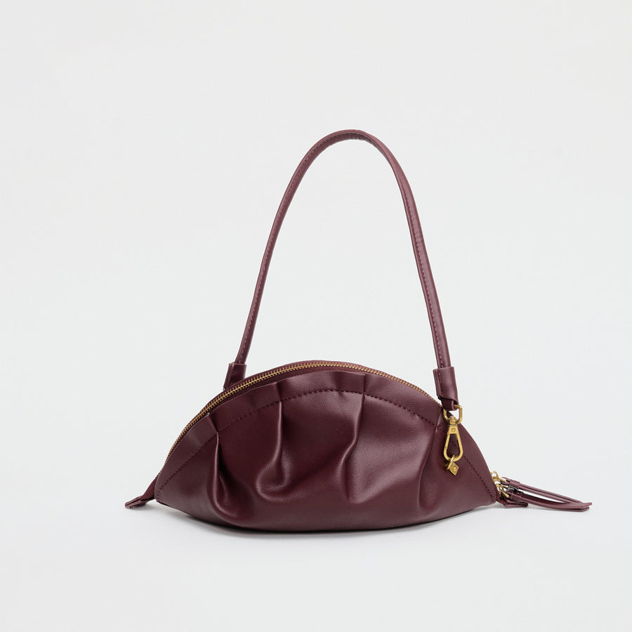 medium gyoza bag burgundy purse handbag crossbody shoulder maroon gold hardware adjustable strap leather zipper madrid spain international fashion imported independent designer slow fashion brand