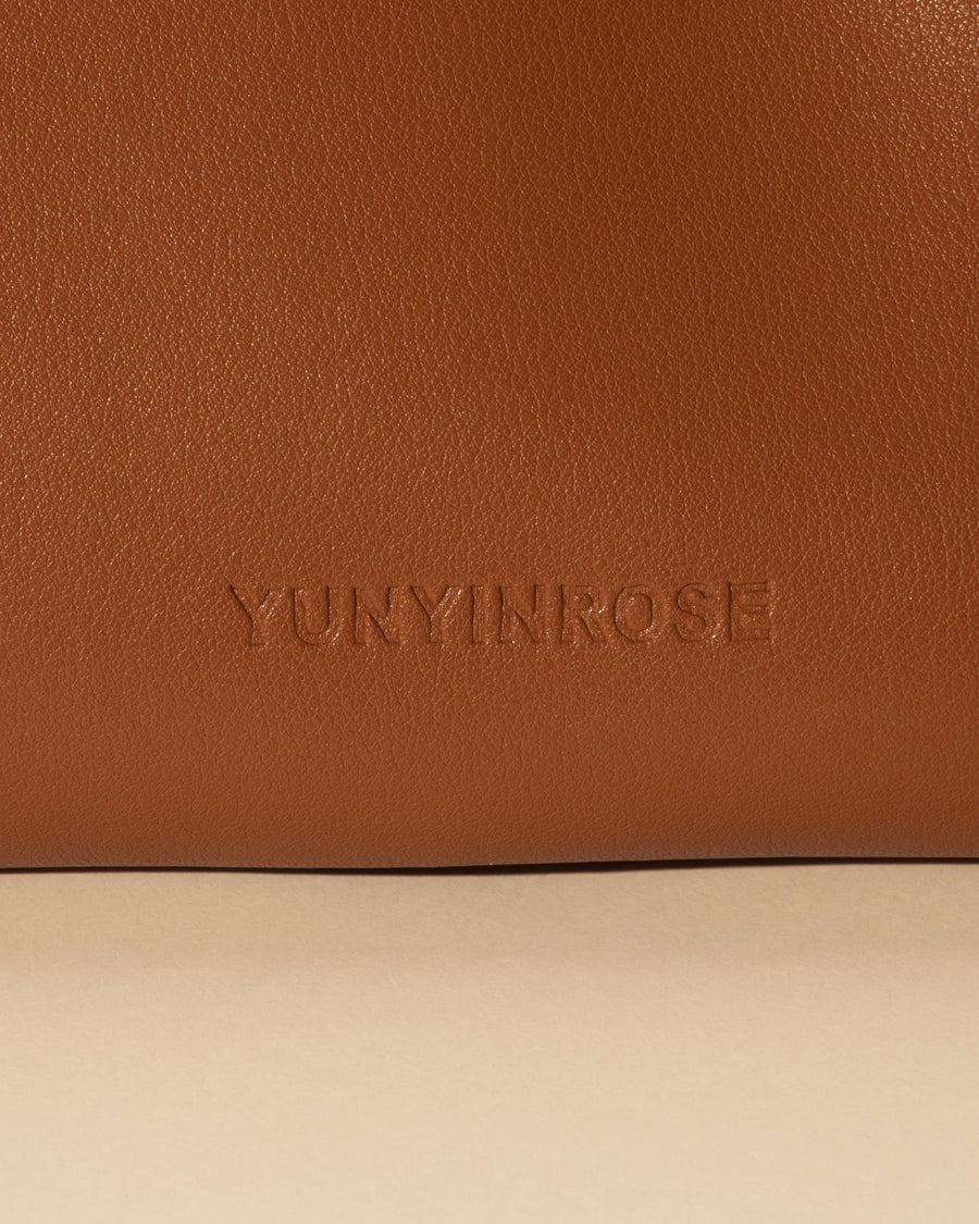 mini gyoza bag brown caramel purse handbag crossbody shoulder tan gold hardware wrist strap adjustable long strap leather zipper madrid spain international fashion imported independent designer slow fashion brand