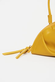 mini gyoza bag mustard yellow purse handbag crossbody shoulder convertible gold hardware short strap adjustable long strap leather zipper madrid spain international fashion imported independent designer slow fashion brand